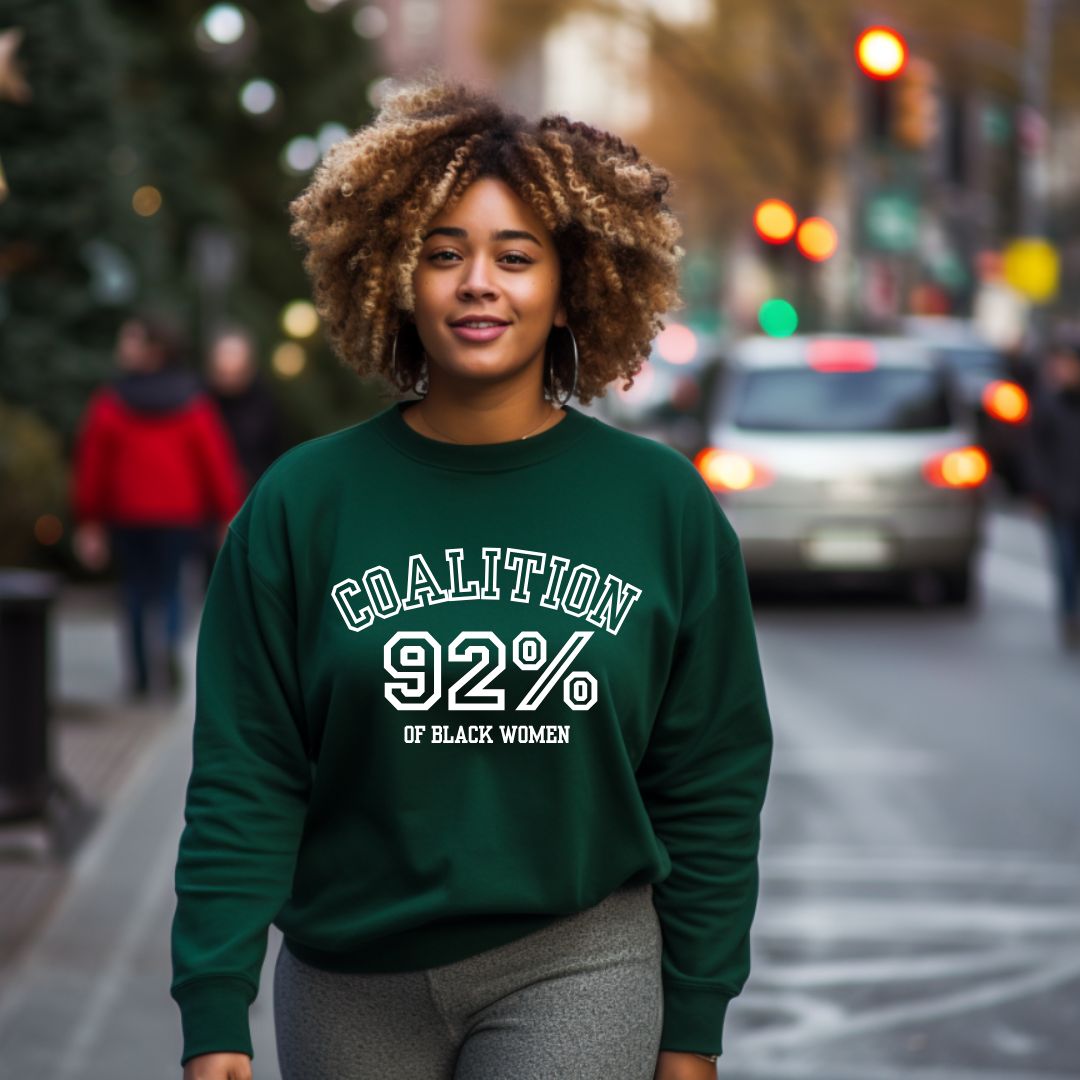 African American women wearing green crewneck sweater with wording Coalition of Black Women 92%