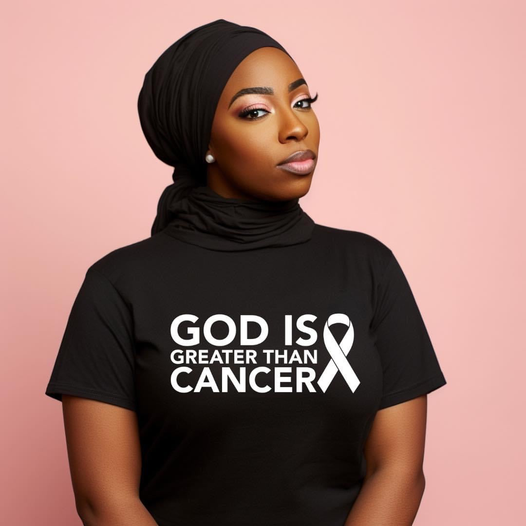 Image featuring African American women with a graphic t-shirt in black. Printed image God is greater than cancer and the cancer ribbon message.
