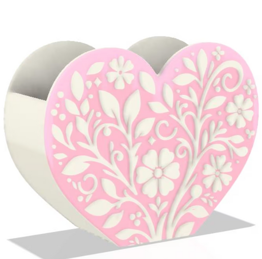 Heart-shaped pen holder with floral design on a white background