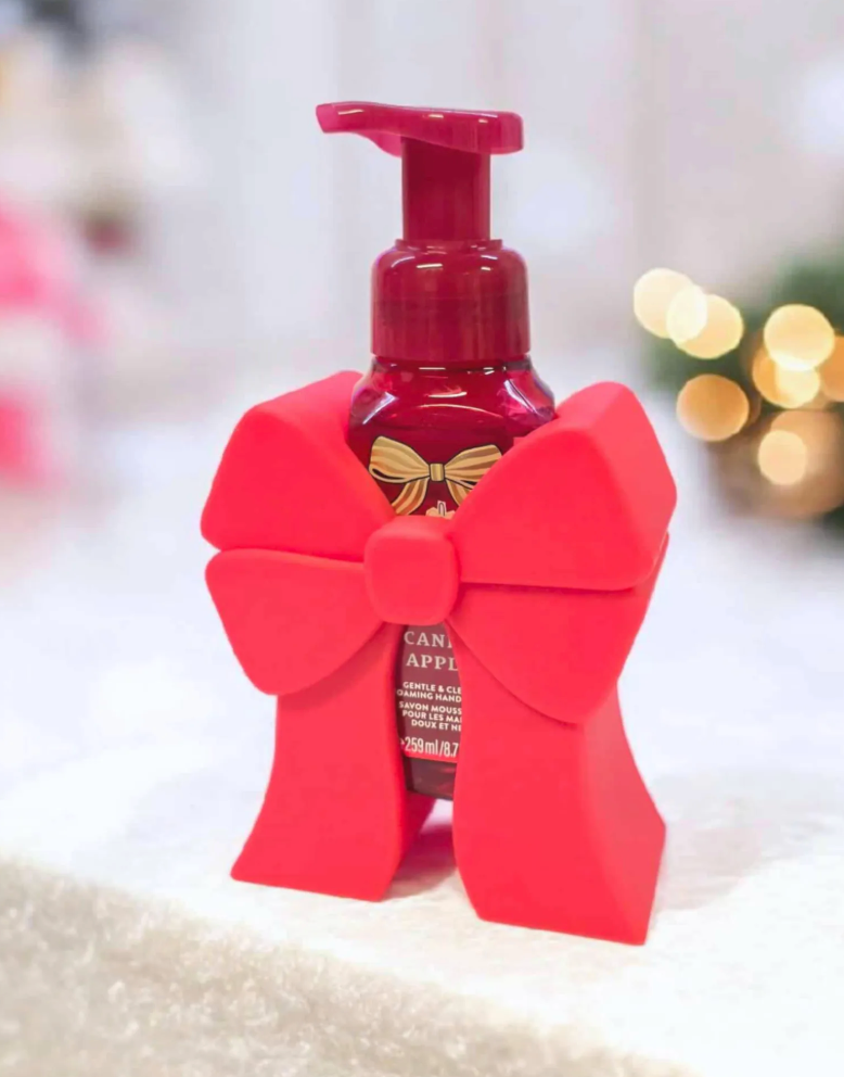 Red bow 3d model soap dispenser decorative holder against a blurred background