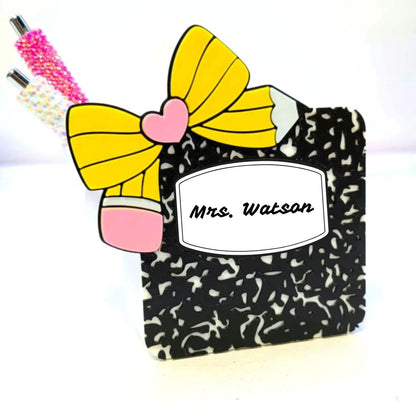 Pencil-shaped container with a yellow bow and pink heart, labeled 'Mrs. Watson', on a white background.