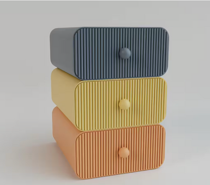 Stack of three textured drawers in gray, yellow, and brown on a light background