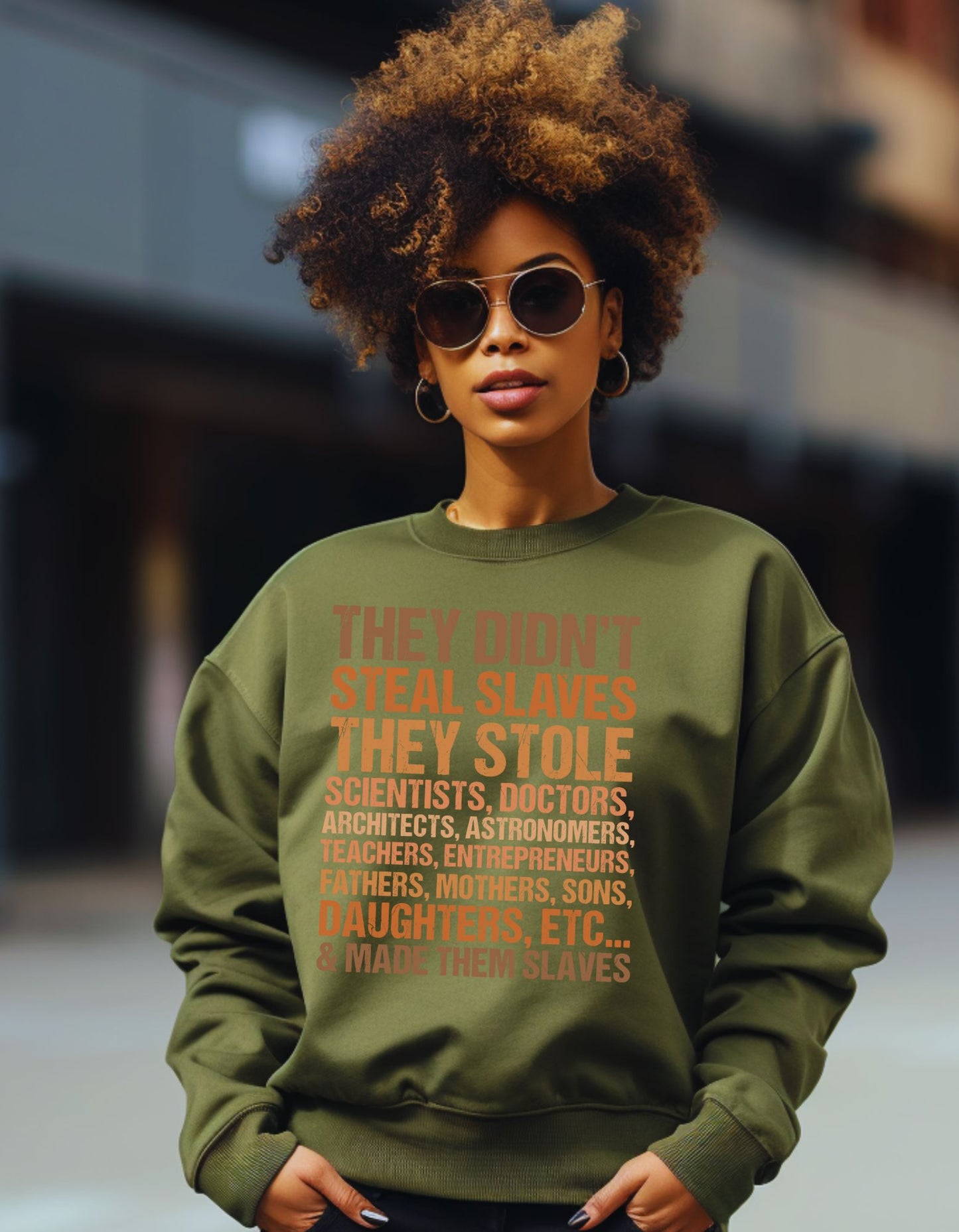 Person wearing a green sweatshirt with a message printed on it, standing against a blurred background.