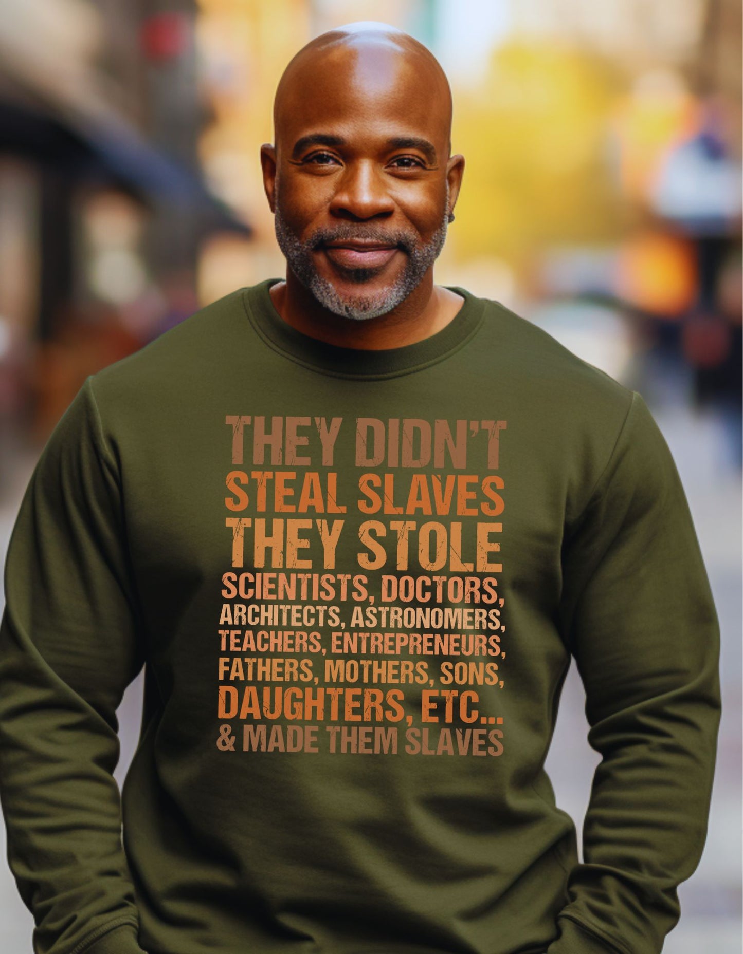 Man wearing a green sweatshirt with a message on it, standing in an urban setting.