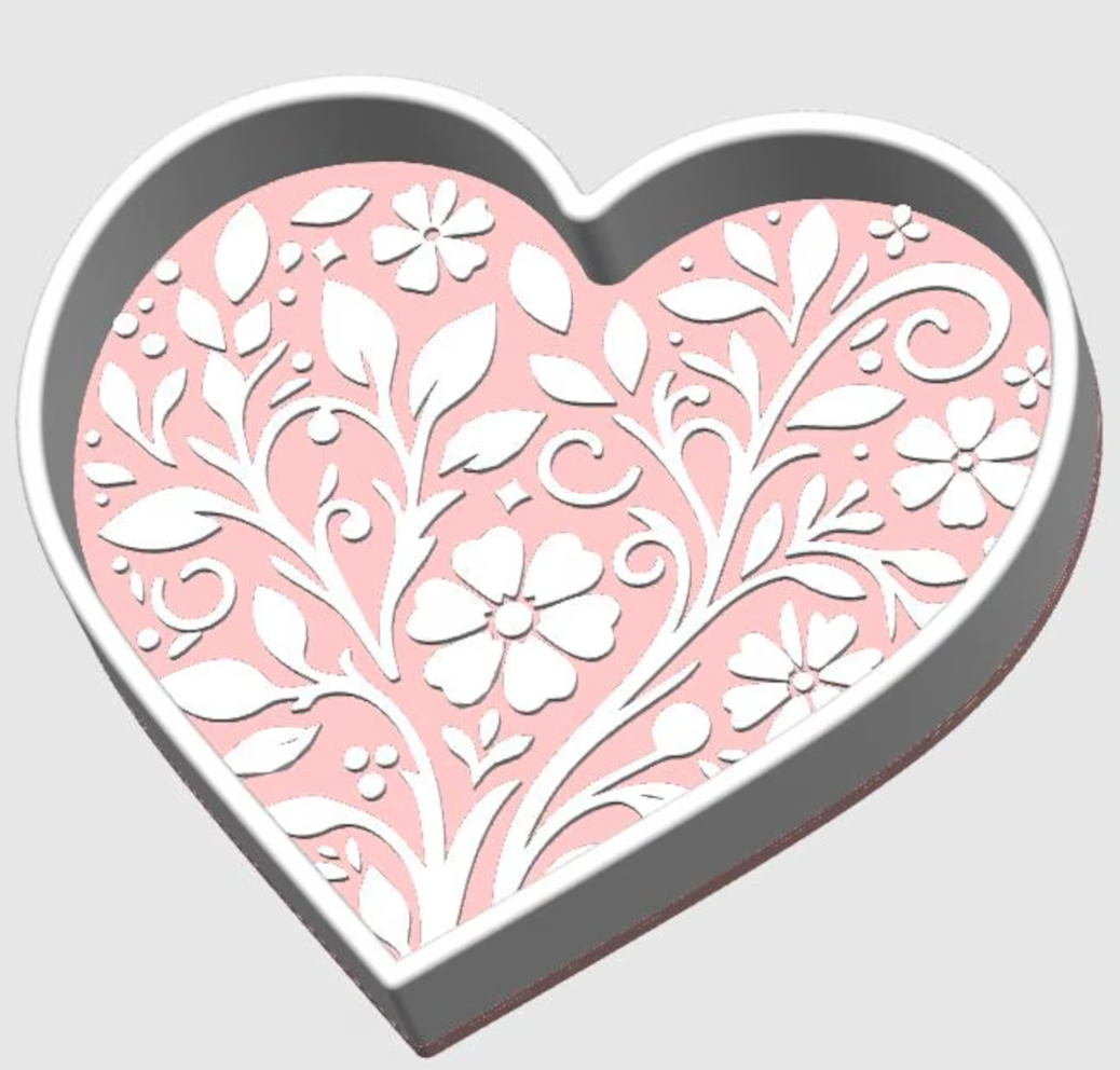 Heart-shaped trinket tray with floral design on a light gray background