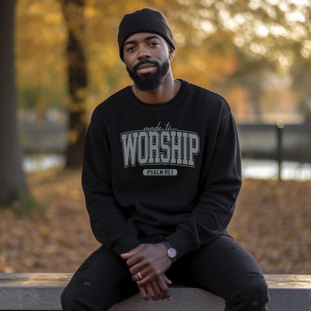 Male wearing black sweater made to worship 