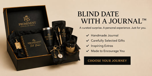Prominent Gifts 'Blind Date with a Journal' gift set displayed in an open black presentation box on a beige background, alongside marketing text describing curated surprises including a handwritten journal, metal tin, pen, candle, and keychain.