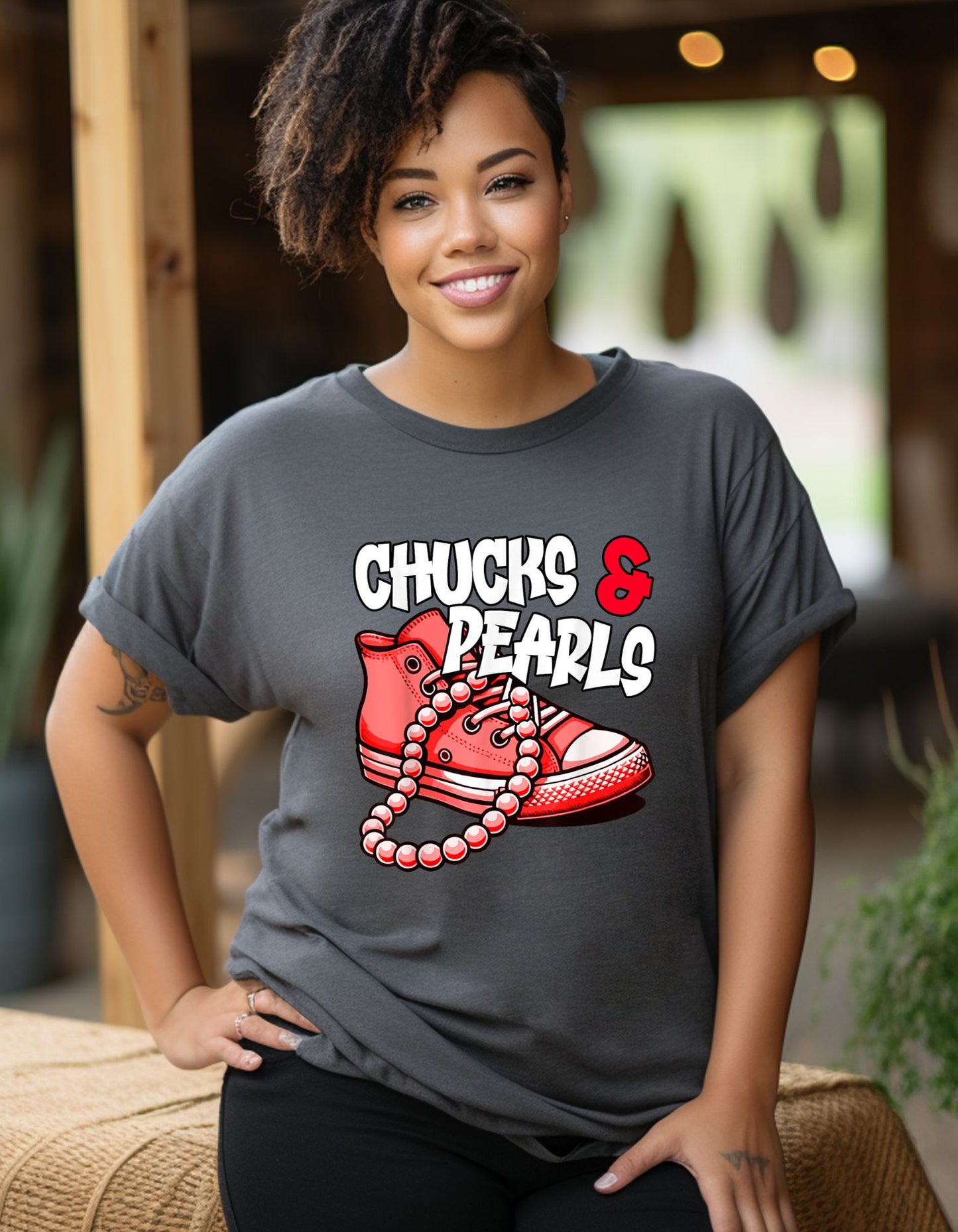 pink chuck and string pearls with font on grey shirt reads chucks and pearls in white