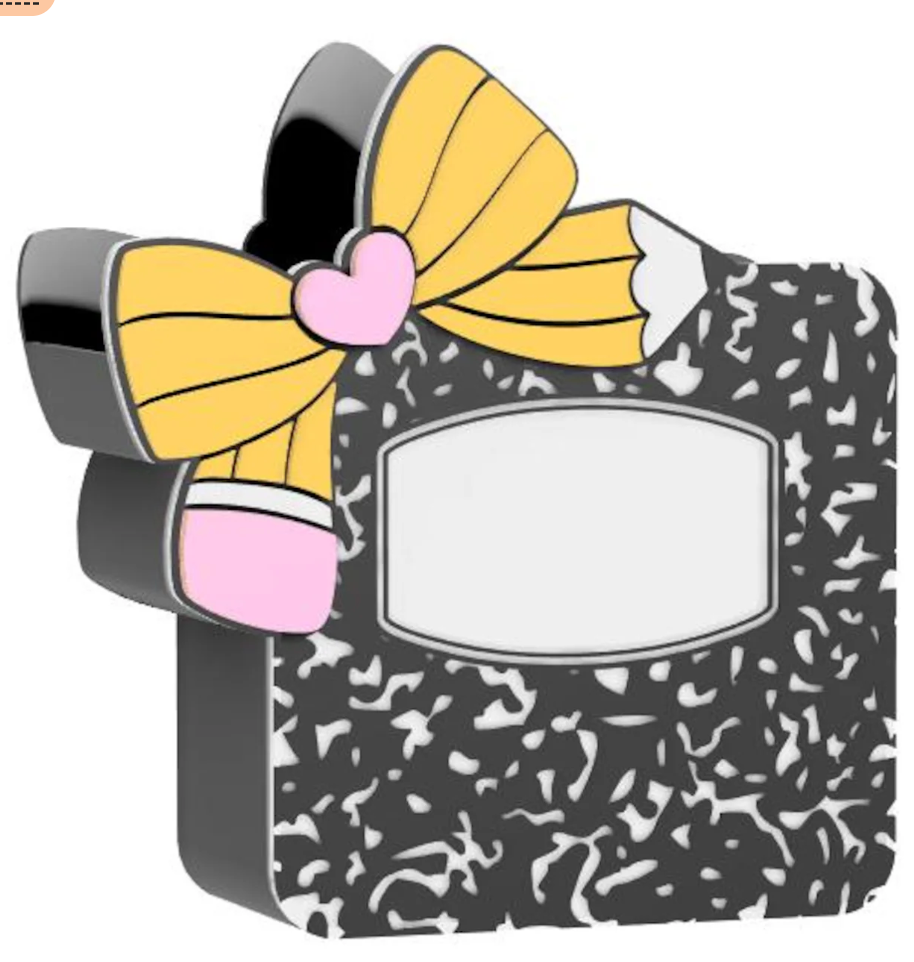 Small rectangular object with a yellow bow and pink heart on a black patterned background