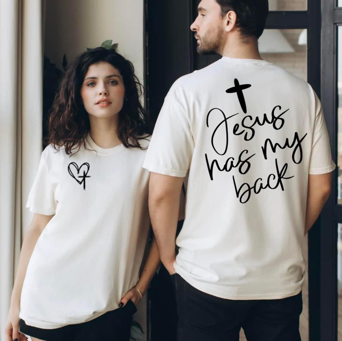 Male and female featuring graphic t-shirt Jesus has my back, on the back. Front pocket featuring a heart and cross